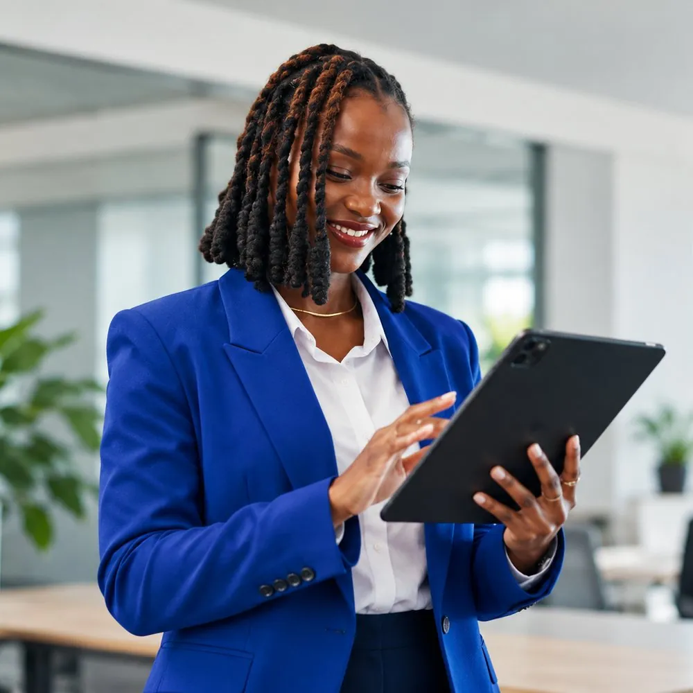 Business owner checking her tablet in a bright office